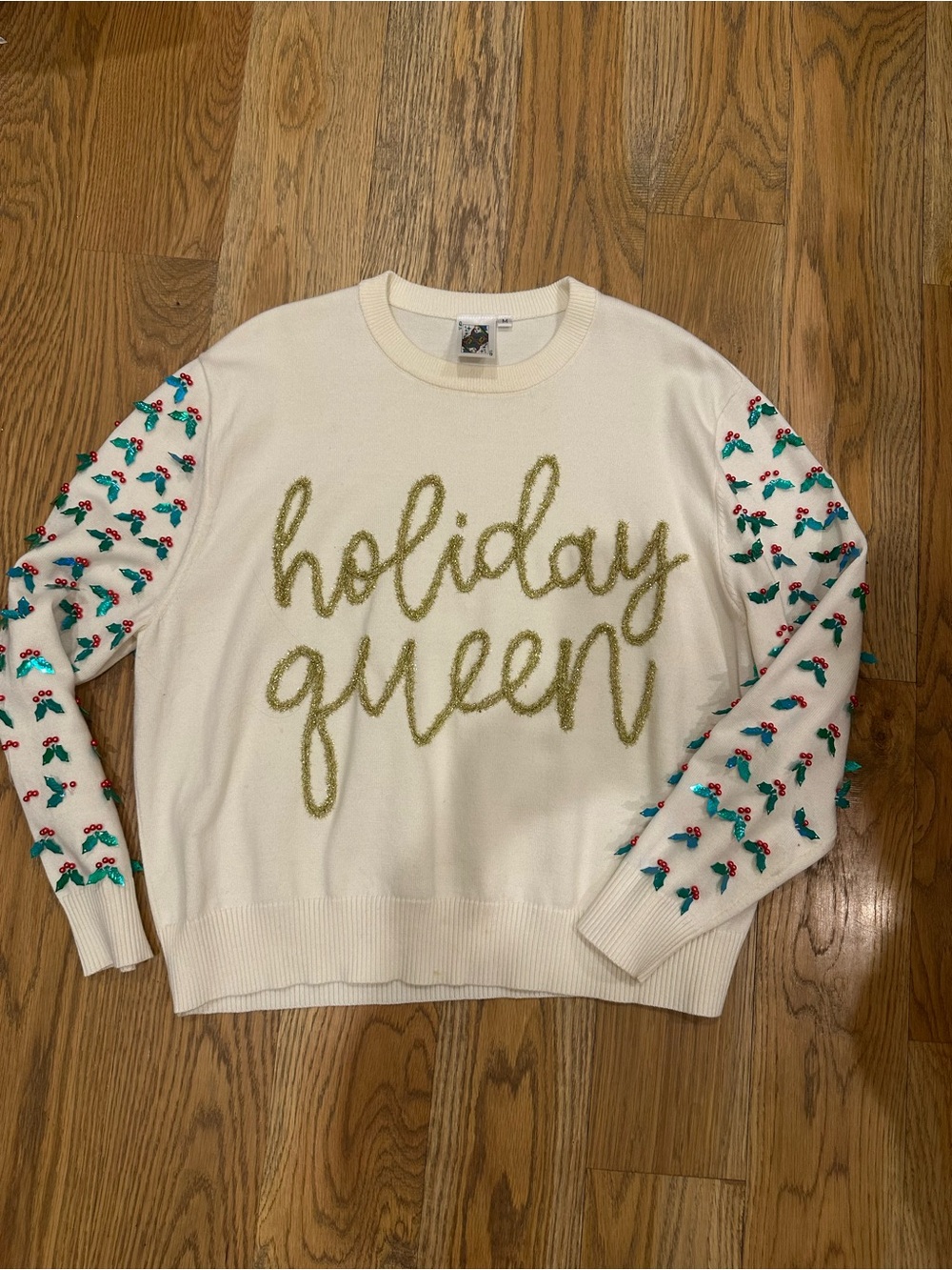 QUEEN OF SPARKLES Cream Sweater with Gold Script and Green-Red Sleeve Detail